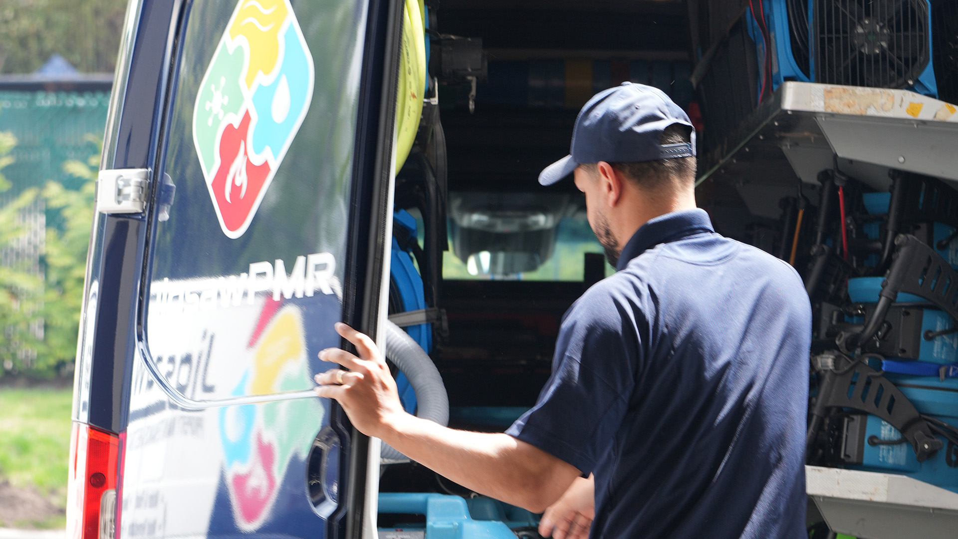 A Jigsaw PMR damage cleanup truck and team member at a property in Cresskill
